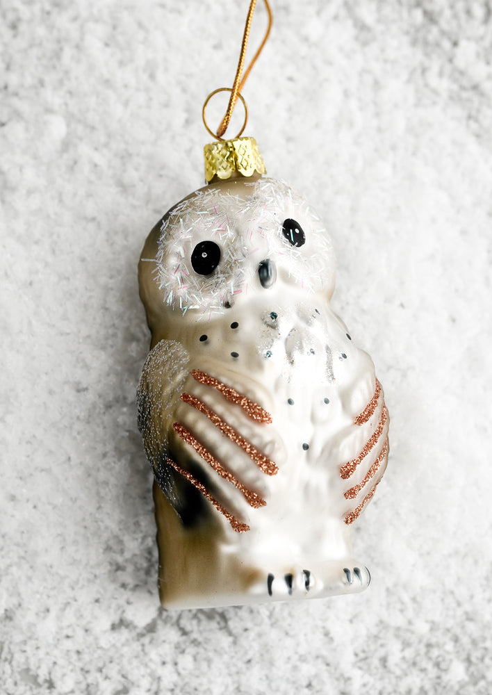 A glass ornament of baby owl.