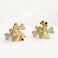 1: Gold stud earrings in shape of three flower cluster with clear crystals.