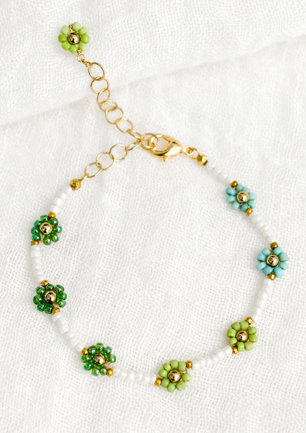 Green Multi: A white beaded bracelet with green and turquoise beaded flowers.