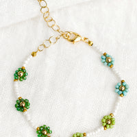 Green Multi: A white beaded bracelet with green and turquoise beaded flowers.