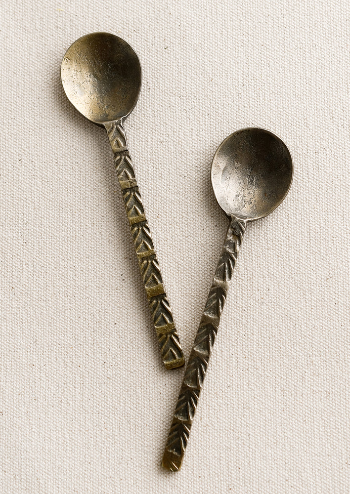 2: A brass spoon with textured handle.