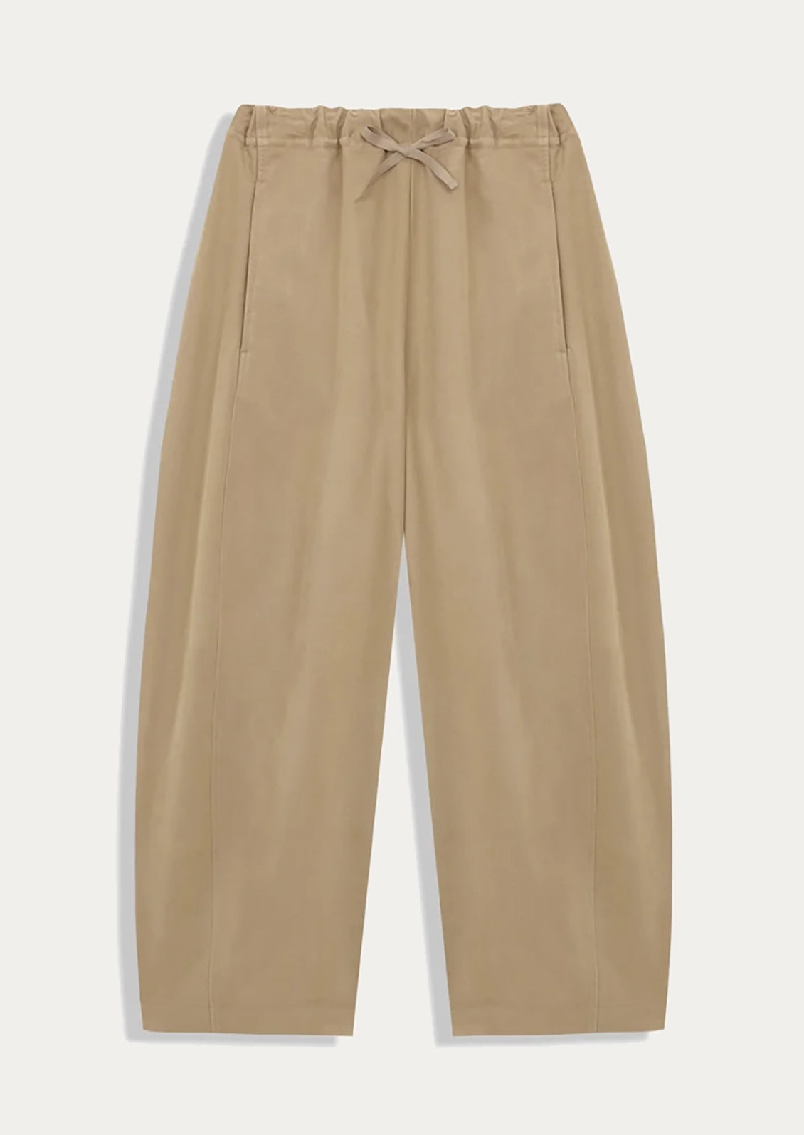 A pair of tan barrel leg pants with elasticized drawstring waist.
