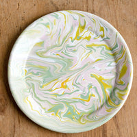1: A round enamel plate with swirl pattern in pastel hues.