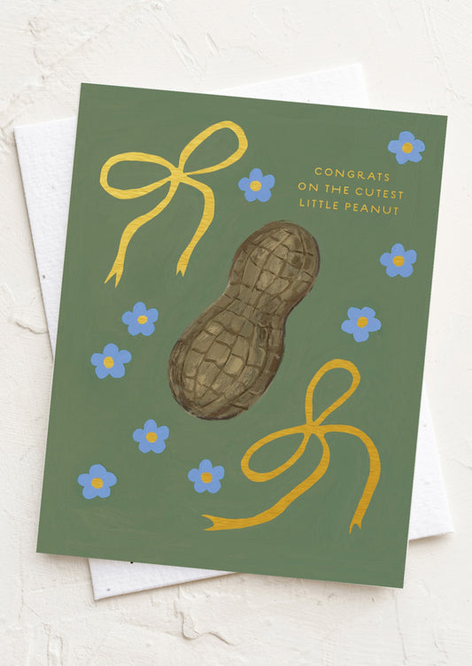 Greeting card with a peanut illustration and decorative elements on a green background