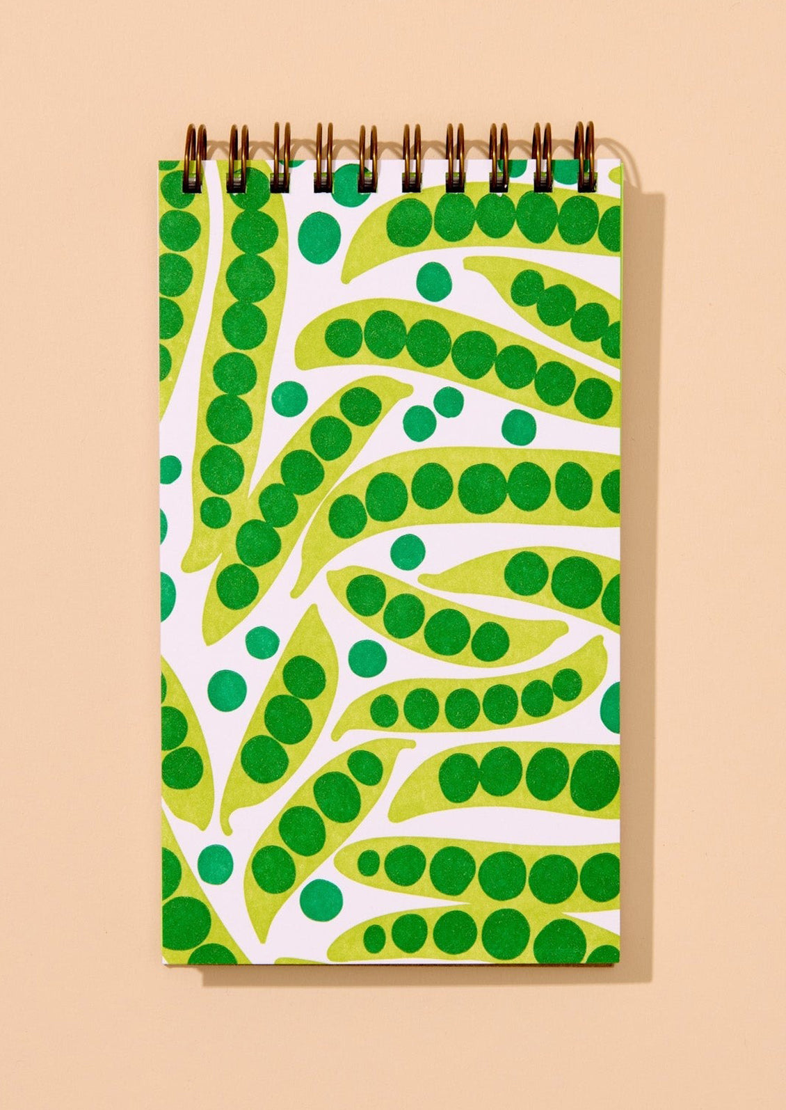 Notebook with green and white peapod pattern on a beige background