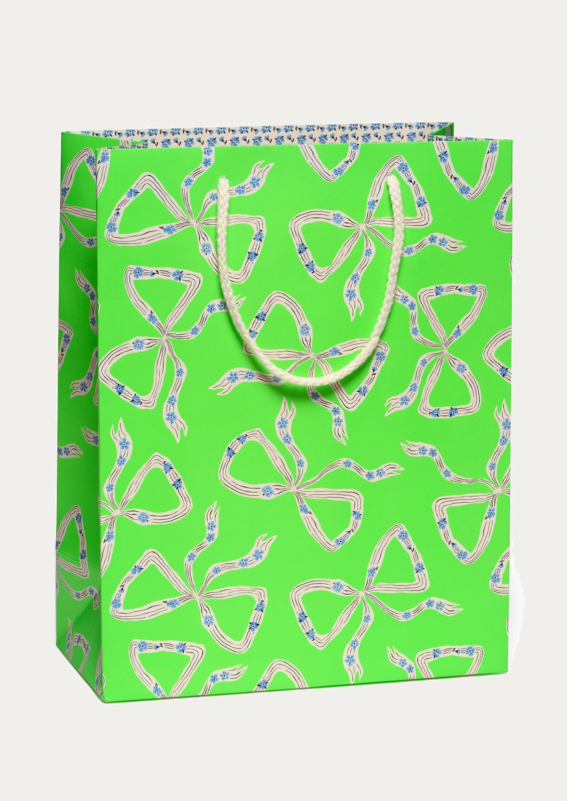Green gift bag with white bow pattern on a white background
