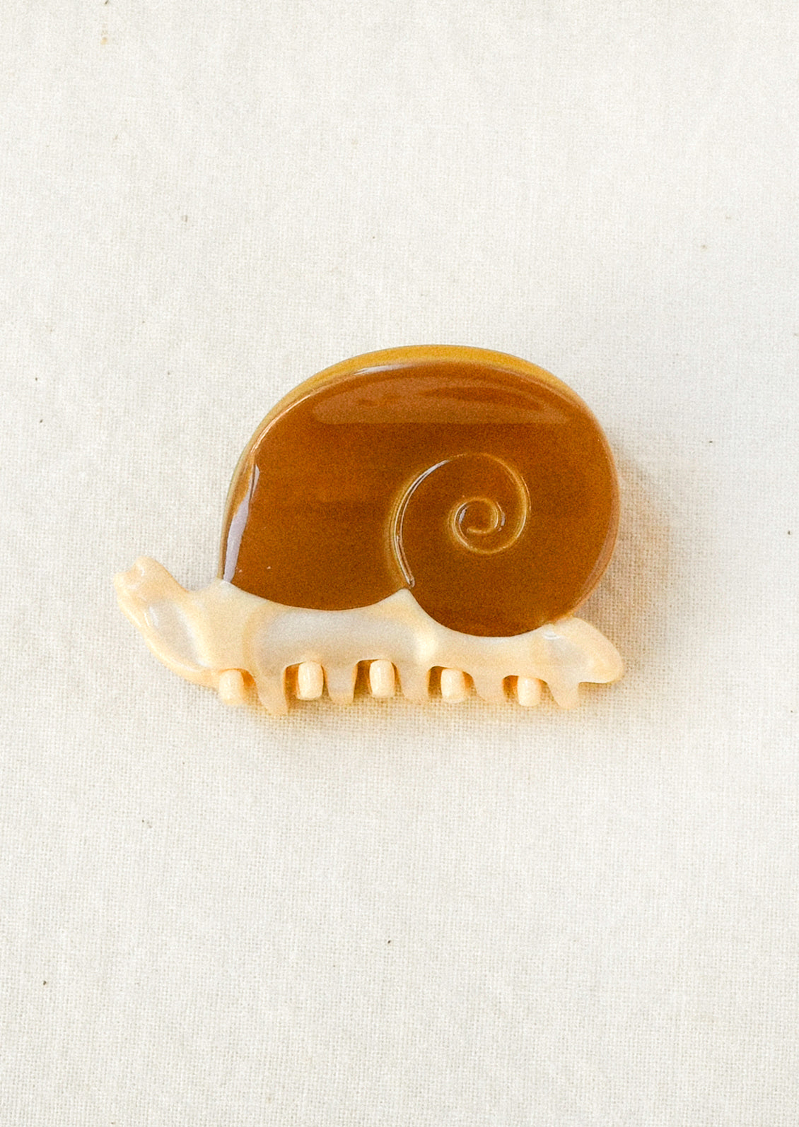 A mini hair clip in the shape of a snail.