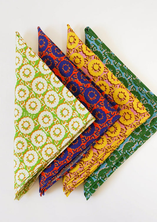 A set of four different brightly colored napkins in floral pattern.