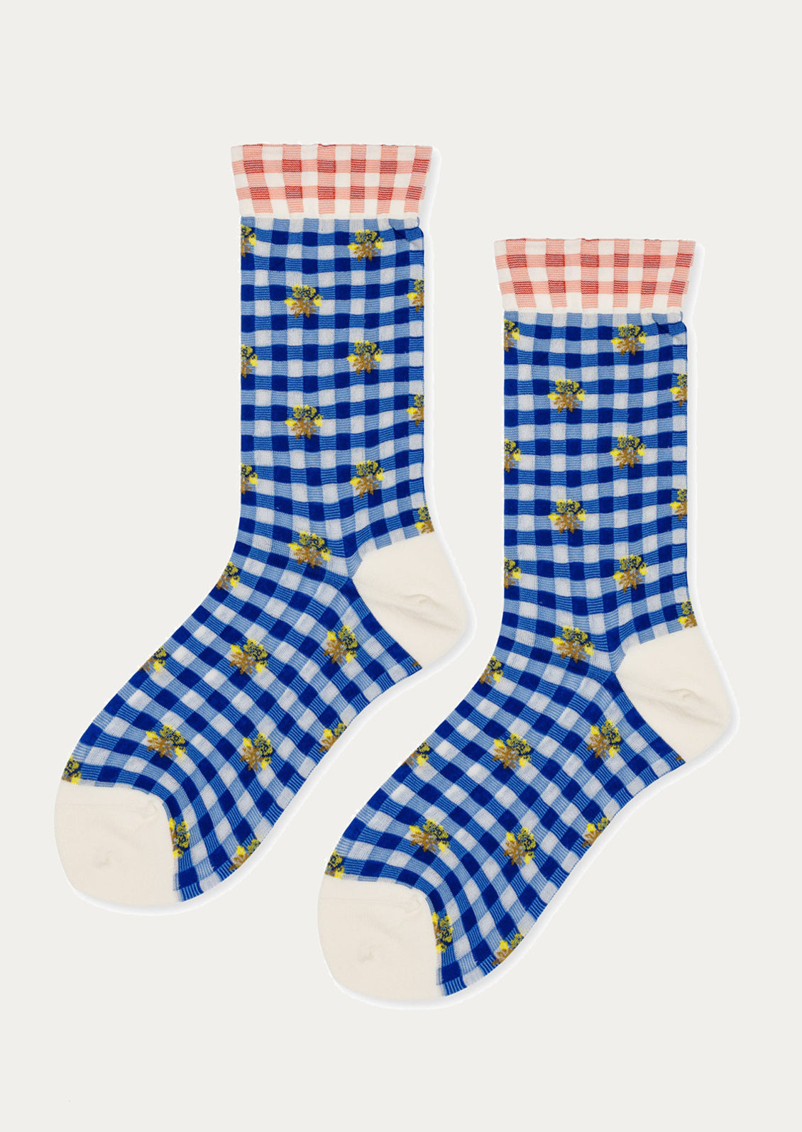 Pair of blue checkered socks with white accents on a white background