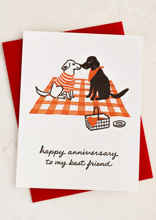 An illustrated card with dogs on a picnic blanket, text reads "happy anniversary to my best friend".