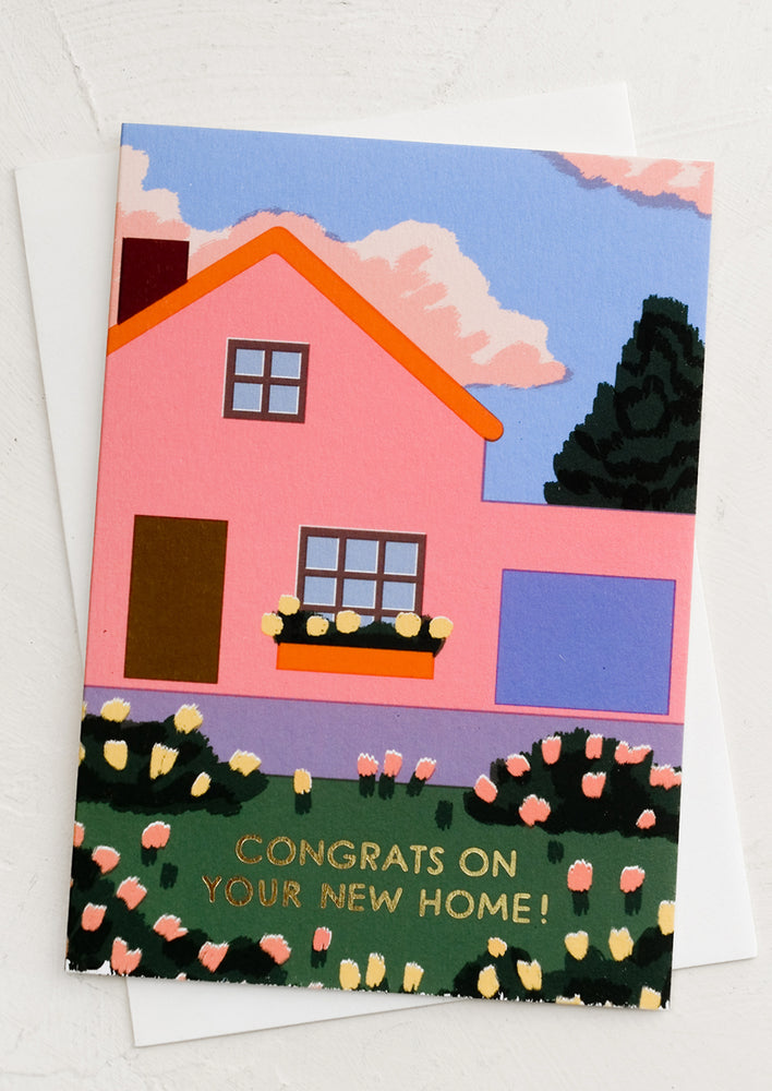 A greeting card with image of pink house and text reading "Congrats on your new home!"