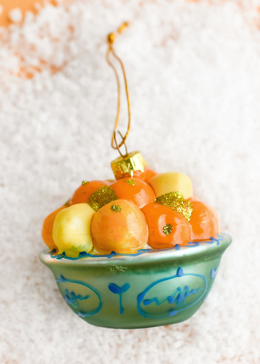 2: A glass ornament depicting a bowl of lemons and oranges.