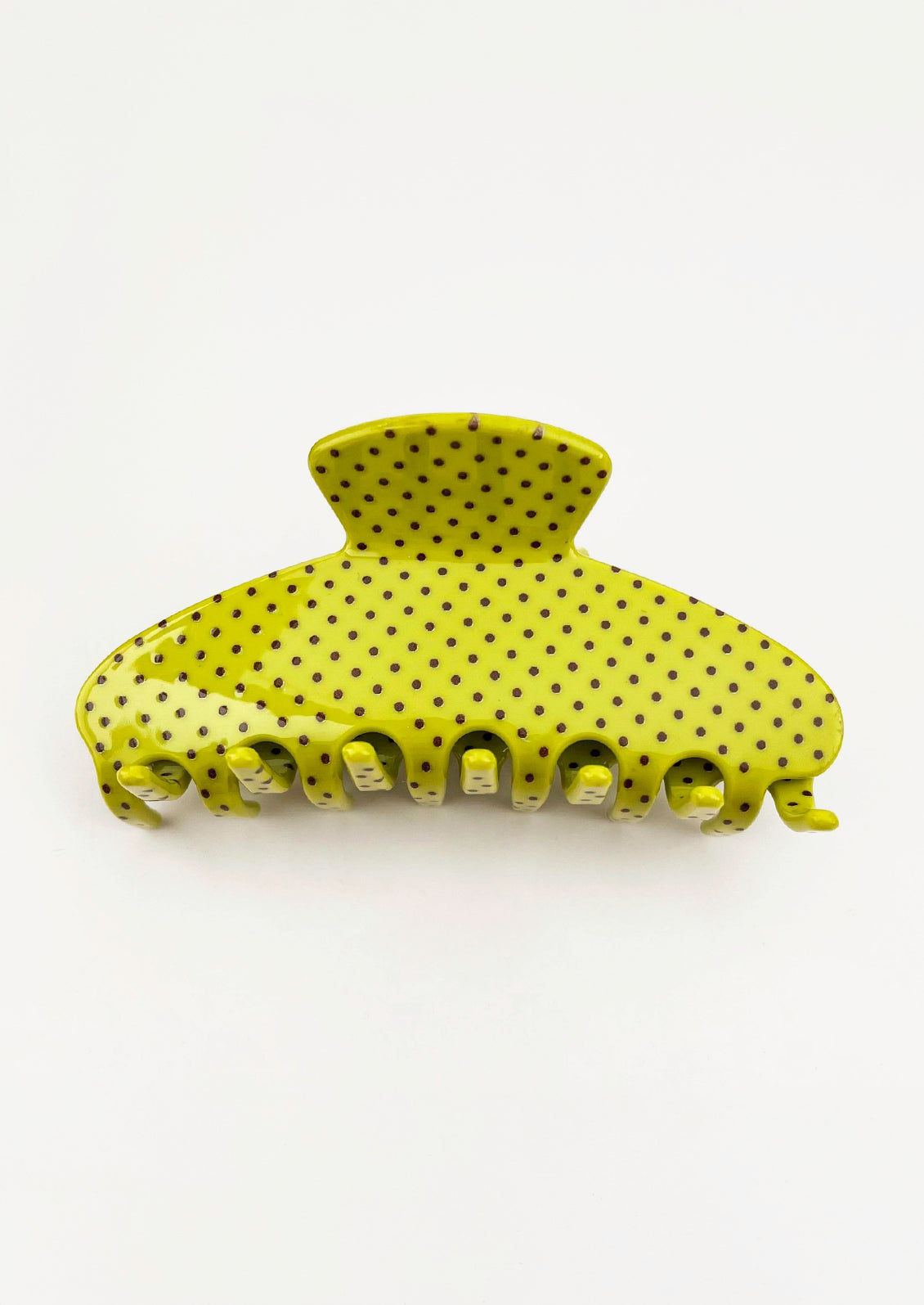 A lime green hair claw with a brown polka dot pattern.