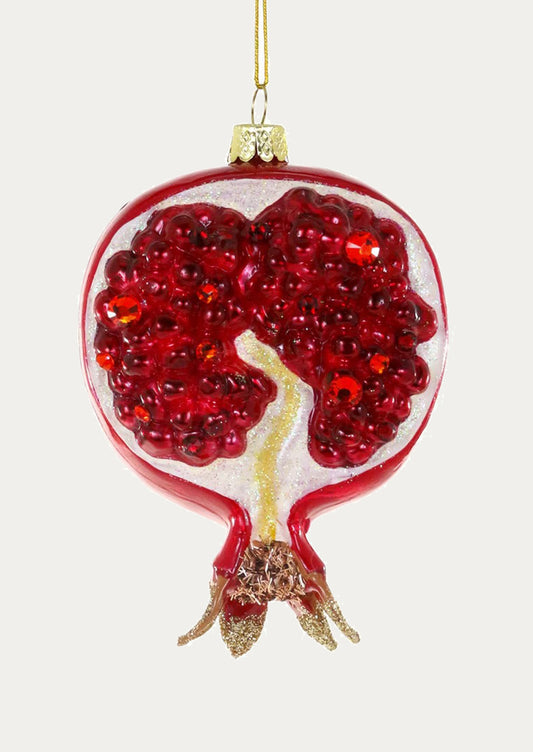 Decorative ornament shaped like a pomegranate with red seeds on a white background