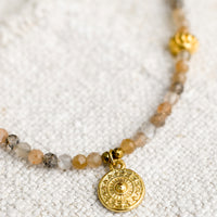 2: A beaded orange moonstone necklace with gold findings.