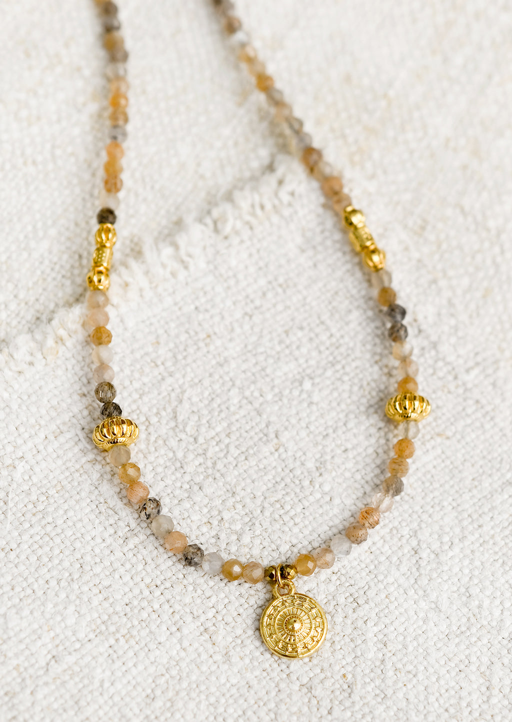 1: A beaded orange moonstone necklace with gold findings.