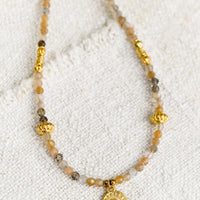 1: A beaded orange moonstone necklace with gold findings.