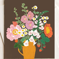 1: A greeting card with floral arrangement on brown background.