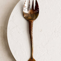 Fork: A copper fork with fish tail handle and oxidized finish.