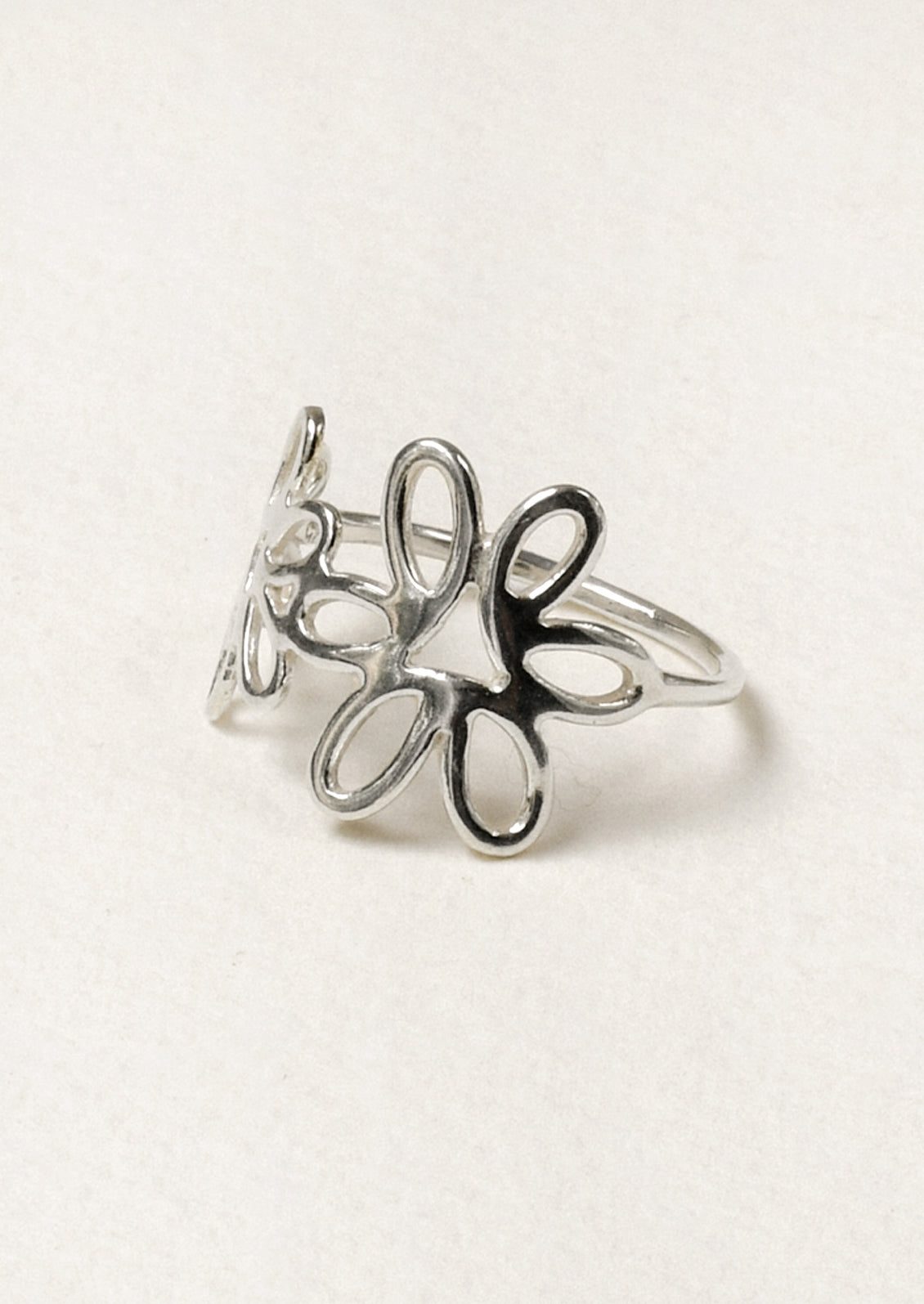 A sterling silver ring with a floral design.