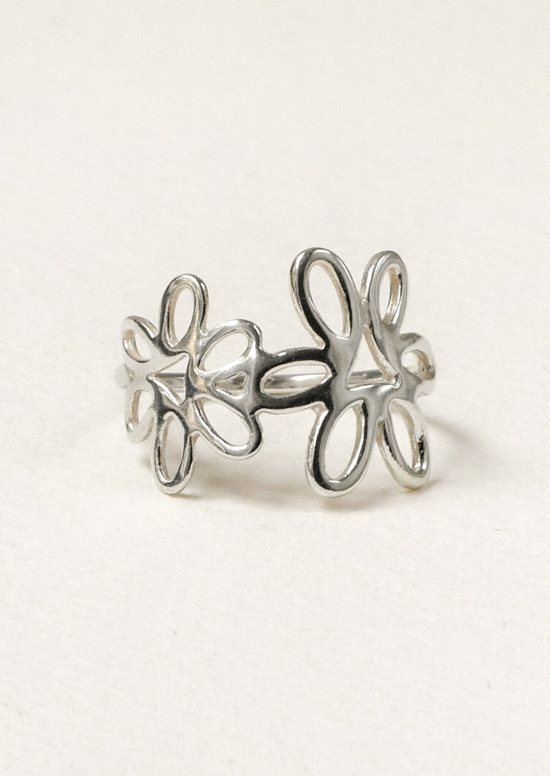 A sterling silver ring with a floral design.