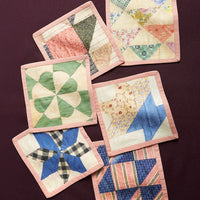1: A set of quilt printed square cocktail napkins in 6 different patterns.