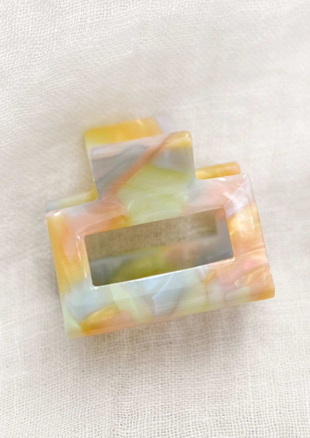 Small: A small hair claw in pastel, prismatic colors.