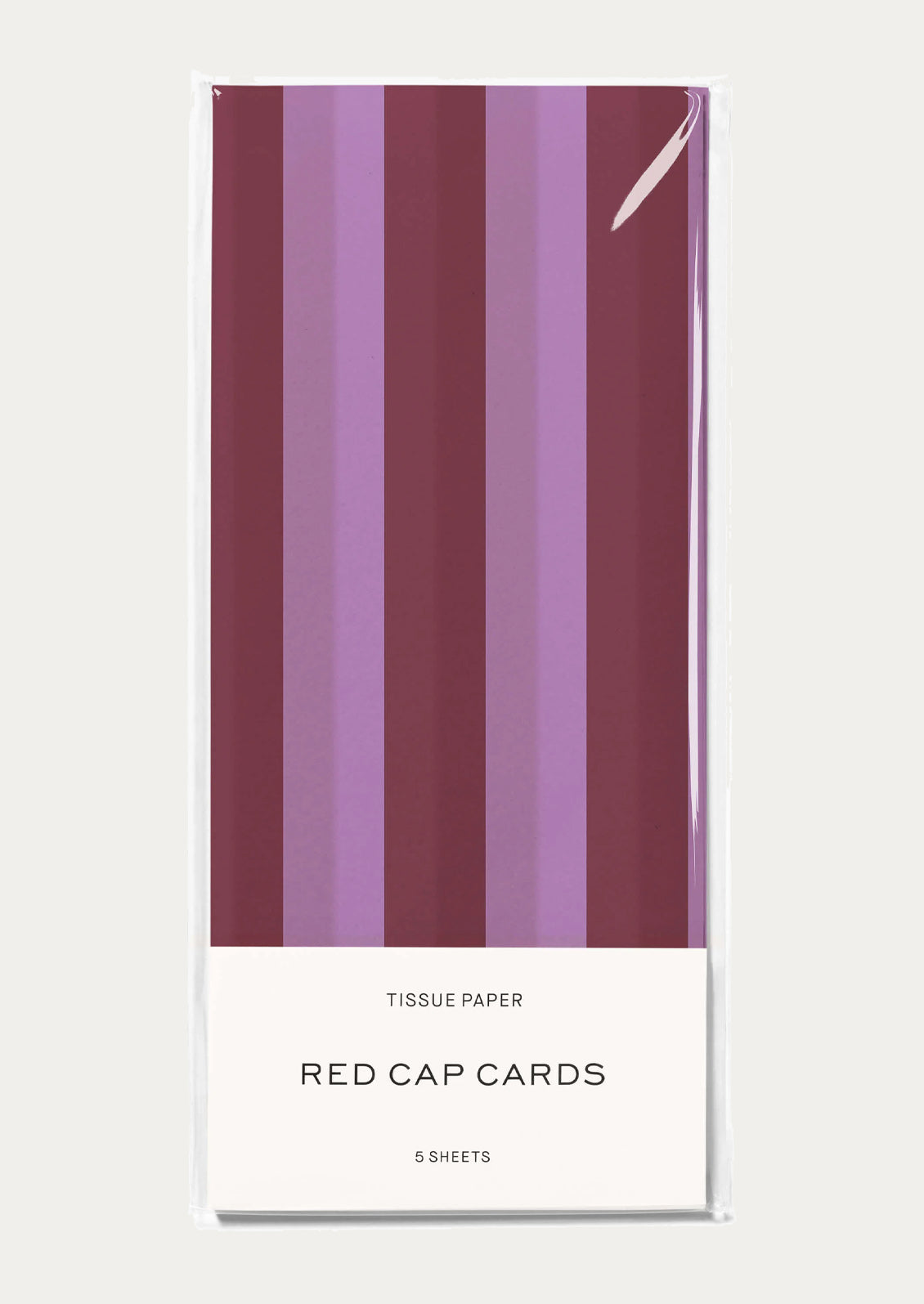 A pack of tissue paper with vertical stripes in shades of burgundy and lavender.