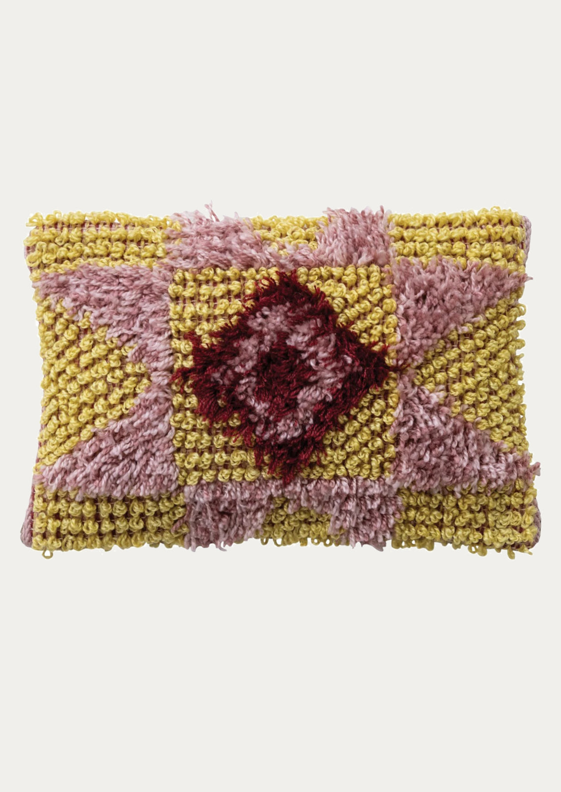 Decorative shag pillow with quilt design.
