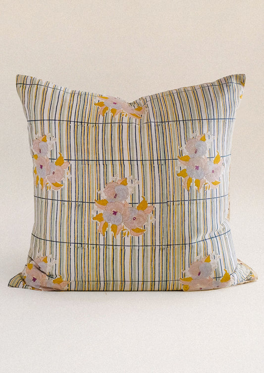 A throw pillow with stripe and floral pattern.
