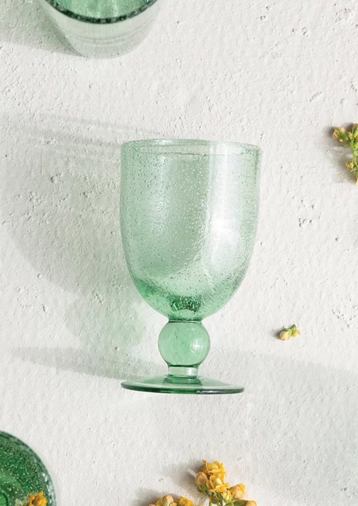 A wine glass made of recycled glass.
