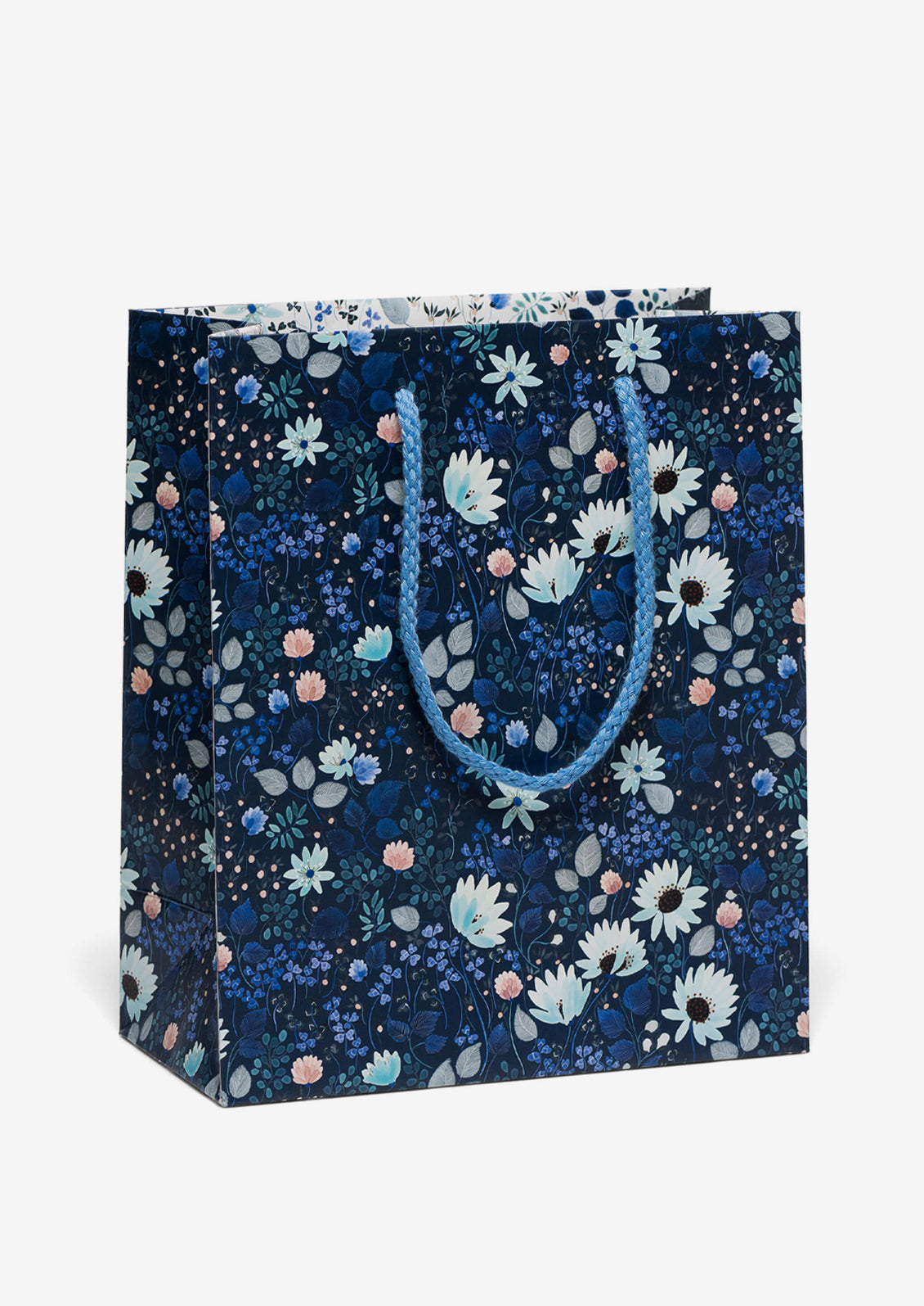 Floral-patterned gift bag with blue handle on a white background