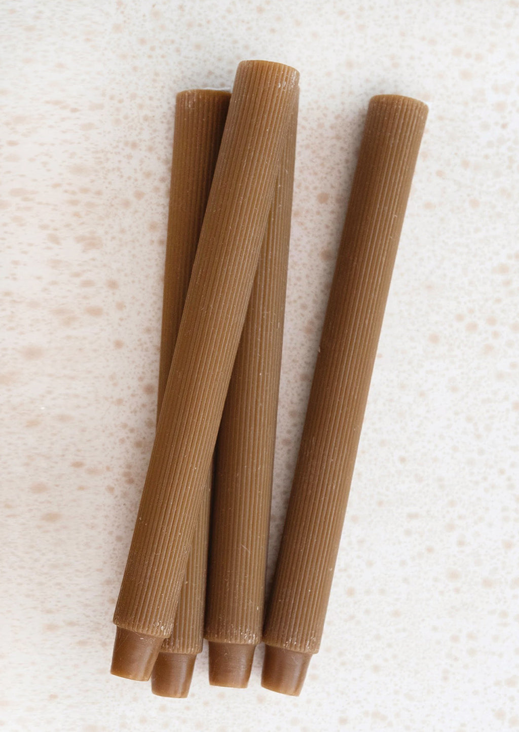 Cider: Taper candles with fine ribbed texture in cider brown.
