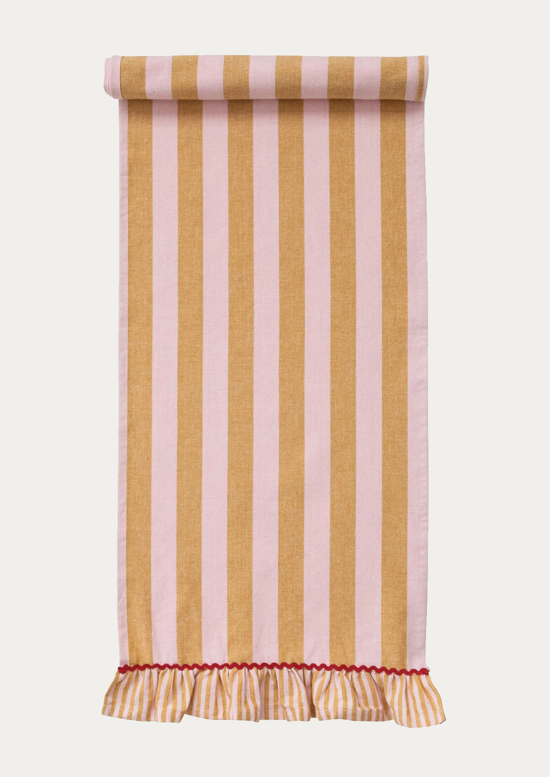 A table runner with wide orange and pink stripe and ruffle trim with red ricrac detailing.