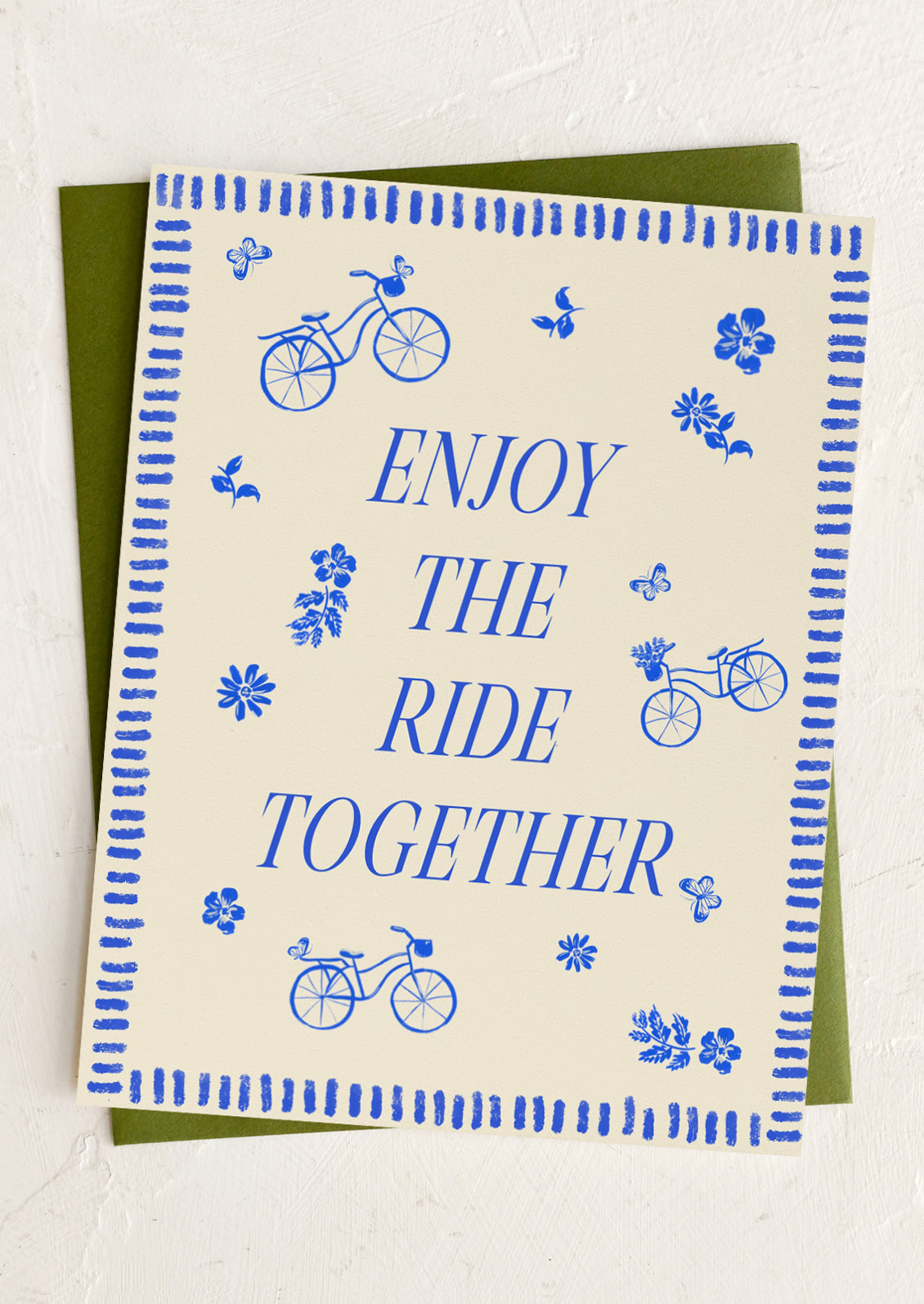 Card with blue bicycles and flowers on a beige background, text 'Enjoy the Ride Together' on a white background.