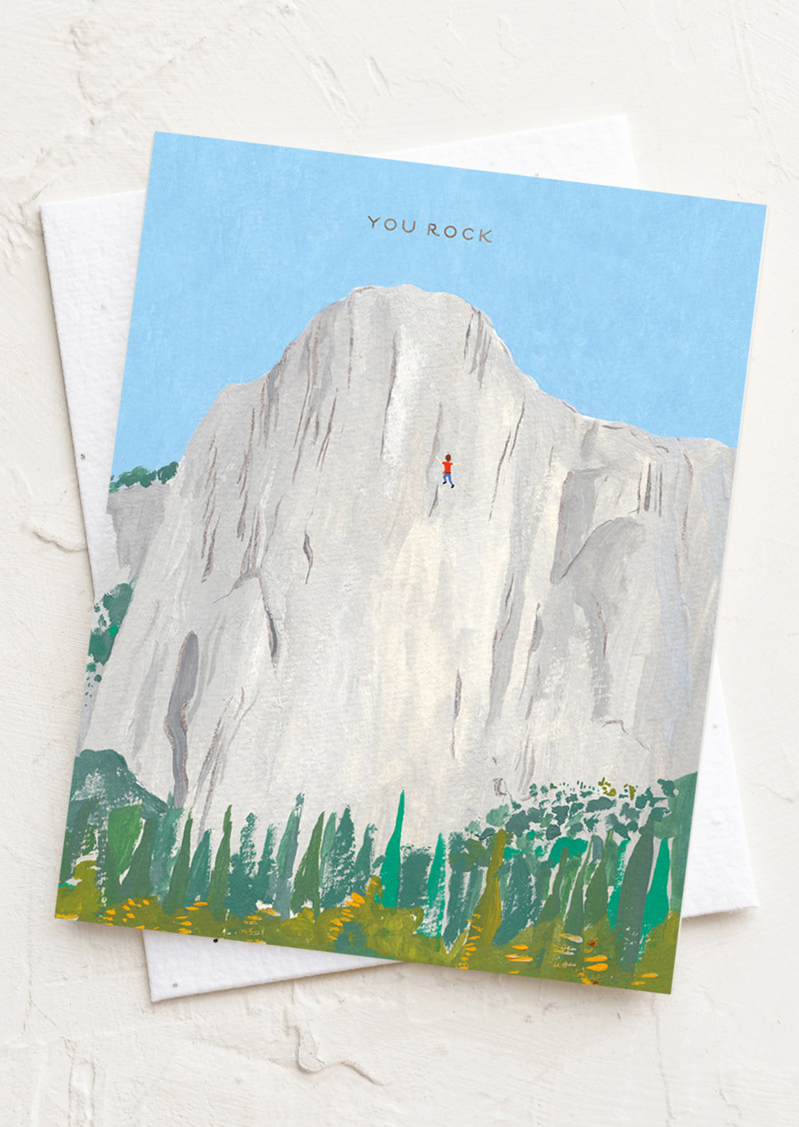 Greeting card with a mountain and climber illustration and 'You Rock' text on a light background.