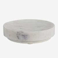2: A round soap dish in white marble.