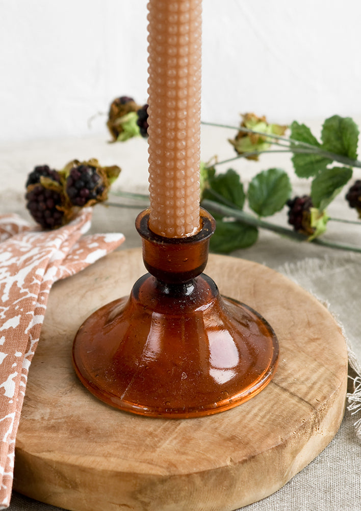 Amber: A Moroccan inspired glass taper holder in amber color.