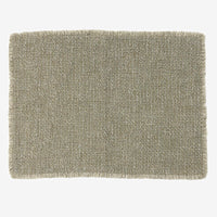 2: A sage green placemat with fringe edges.