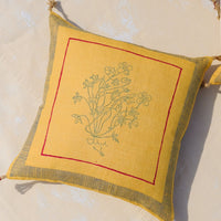 Mustard: A yellow throw pillow in linen with framed floral outline.