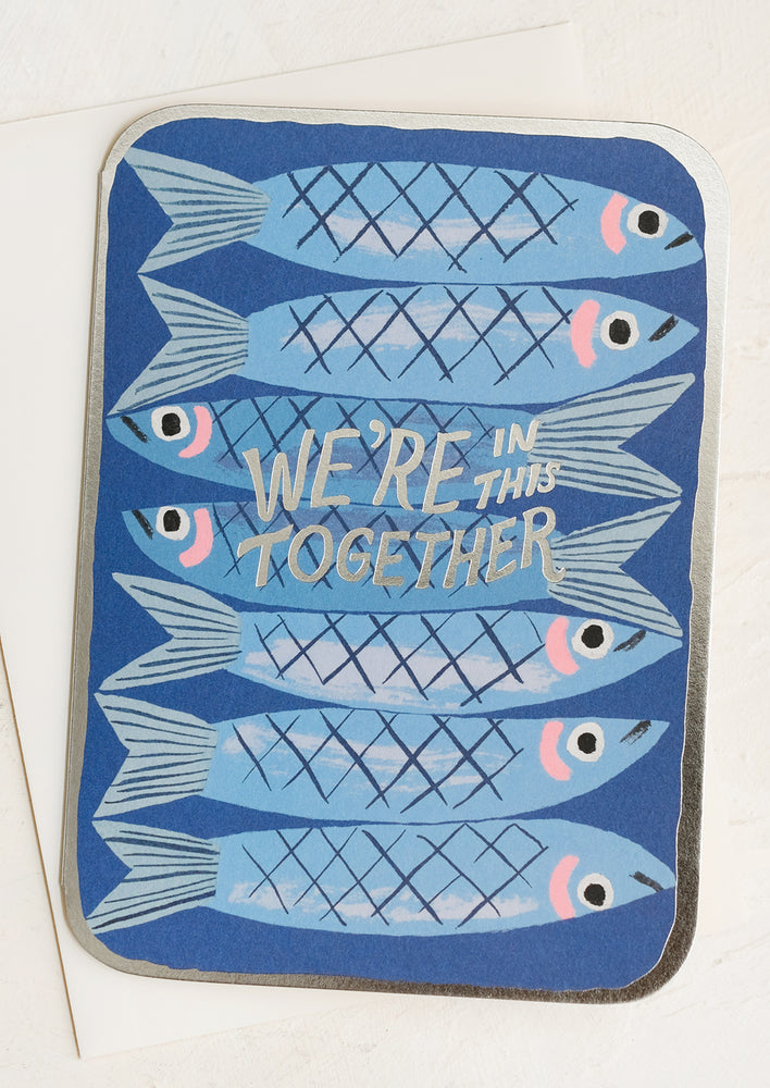 A card that looks like a tin of sardines, reads "We're in this together".