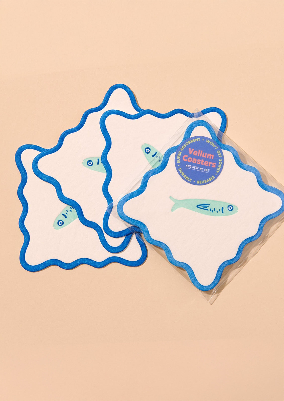 Decorative paper coasters with wavy edges and fish motif.