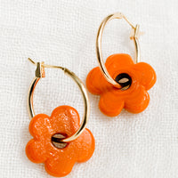 Clementine: A pair of gold hoop earrings with single orange flower bead.