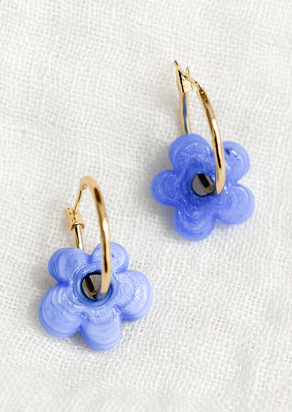 Cornflower: A pair of gold hoop earrings with single periwinkle flower bead.