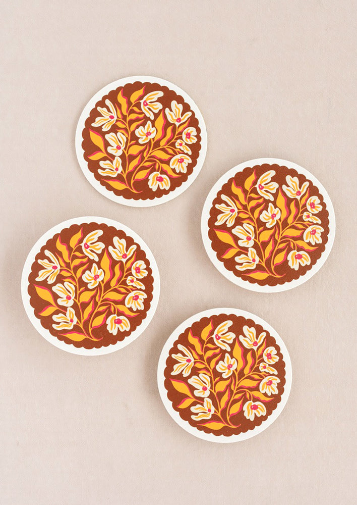 A set of paper coasters in scalloped floral print.