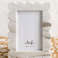 2: A scalloped marble picture frame in solid grey marble.