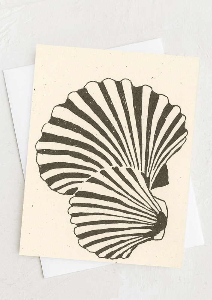 1: A creme colored greeting card with black and white shell design.