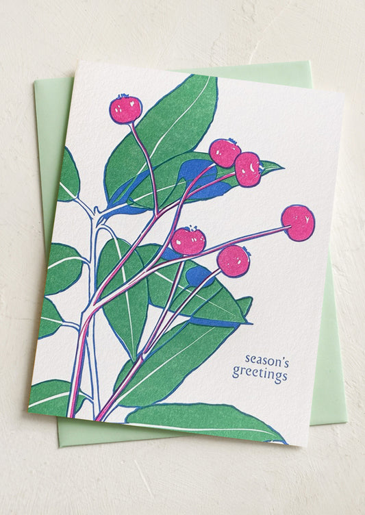 A floral print greeting card, text reads "Season's Greetings".