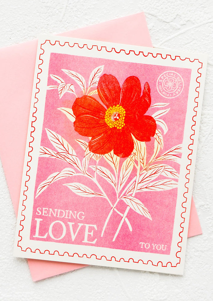 Greeting card illustrated to look like a floral printed postage stamp, text at bottom reads "Sending Love To You"