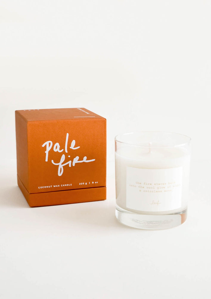 Pale Fire: A glass candle with a white label sits next to a peach colored box reading "lost letters" in black cursive text.